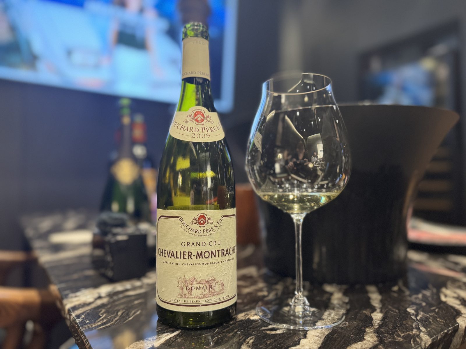 Bouchard Père & Fils Chevalier-Montrachet 2009 beside its glass